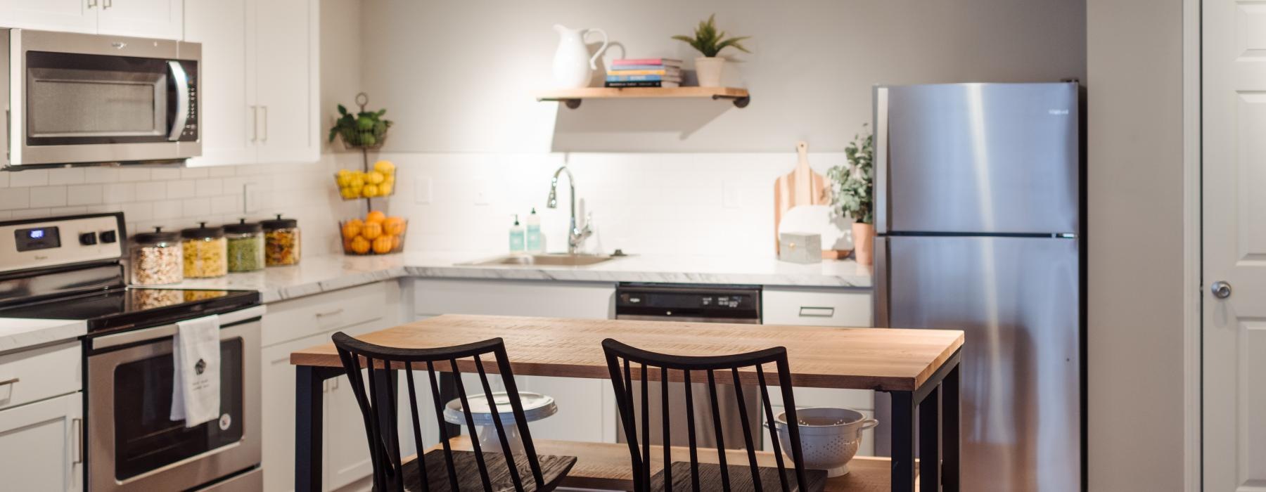 a kitchen with a table and chairs