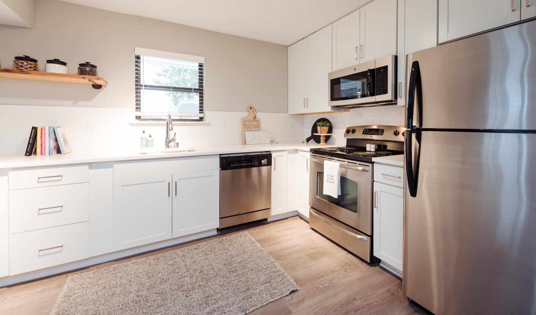 a kitchen with white cabinets